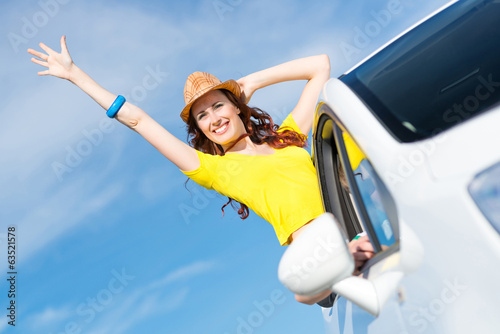 Photo: Young woman got out of car window Young woman got out of car window