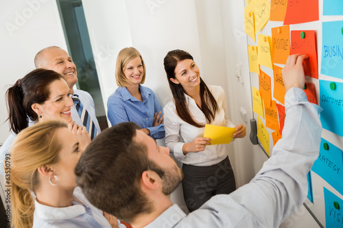 Photo: Businessman Explaining Labels On Whiteboard Businessman Explaining Labels On Whiteboard