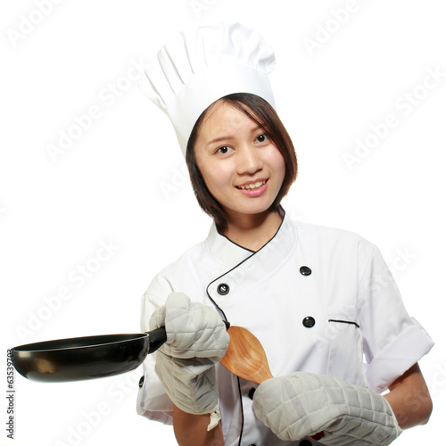 Photo: Young and happy beautiful girl preparing lunch Young and happy beautiful girl preparing lunch
