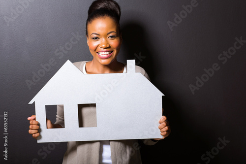 Photo: african woman holding a home symbol african woman holding a home symbol