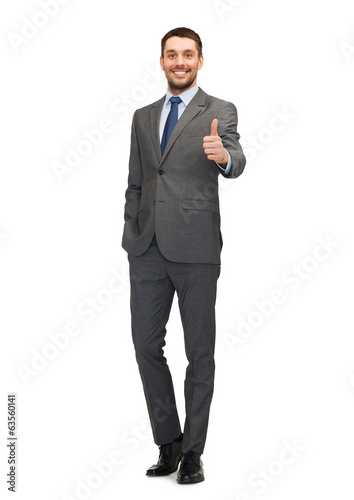 Photo: handsome buisnessman showing thumbs up handsome buisnessman showing thumbs up