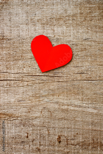 Photo: Red paper heart on grunge wooden background Red paper heart on grunge wooden background