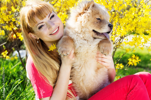 Photo: Girl with her dog on the nature Girl with her dog on the nature