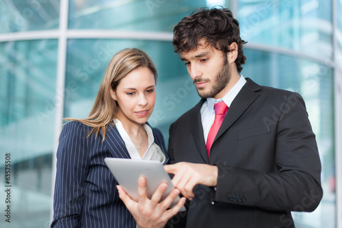 Photo: Business people using a digital tablet Business people using a digital tablet