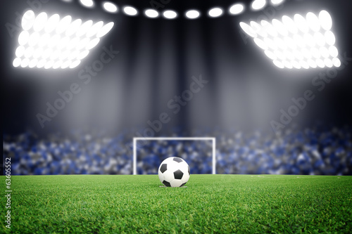 Photo: Soccer ball on field in stadium at night Soccer ball on field in stadium at night