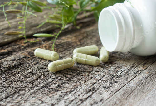 Photo: Herb capsule on old wood Herb capsule on old wood