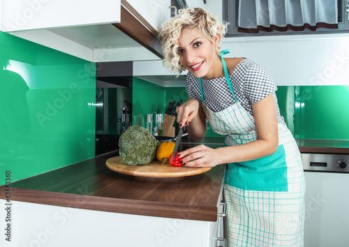 Photo: Housewife cooking healthy food at home Housewife cooking healthy food at home
