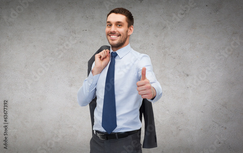 Photo: handsome buisnessman with jacket over shoulder handsome buisnessman with jacket over shoulder