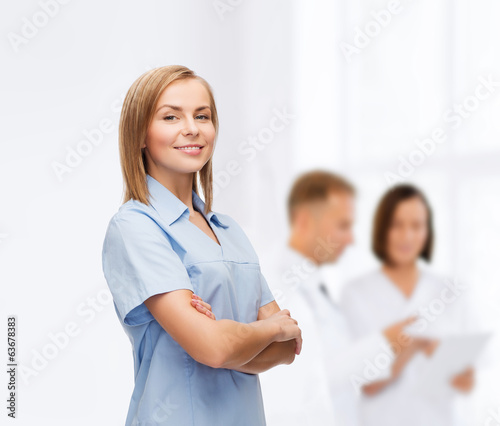 Photo: smiling female doctor or nurse smiling female doctor or nurse