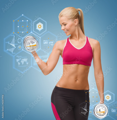 Photo: smiling woman lifting steel dumbbell smiling woman lifting steel dumbbell