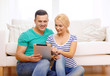 smiling happy couple with tablet pc at home smiling happy couple with tablet pc at home