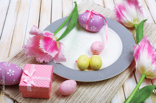 Photo: Easter table setting with tulips and eggs Easter table setting with tulips and eggs