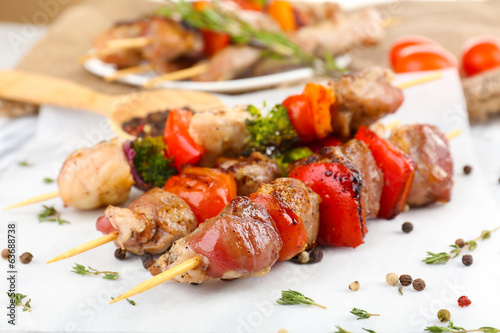 Photo: Pork kebab on wooden table close up Pork kebab on wooden table close up