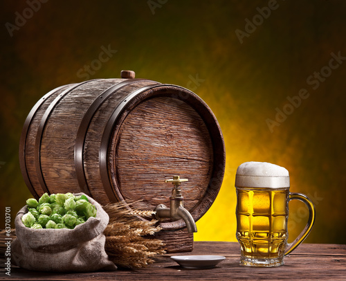 Photo: Beer glass, old oak barrel, wheat ears and hops. Beer glass, old oak barrel, wheat ears and hops.