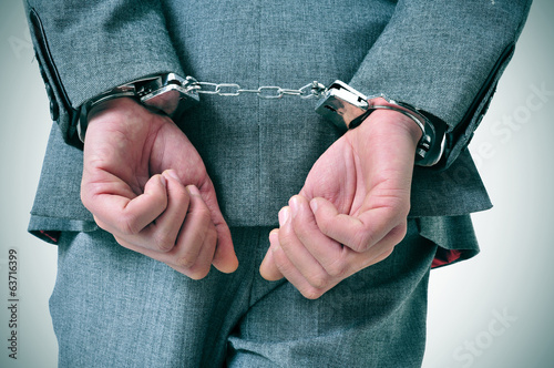 Photo: handcuffed man handcuffed man