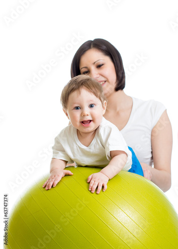 Photo: mother with baby having fun with gymnastic ball mother with baby having fun with gymnastic ball