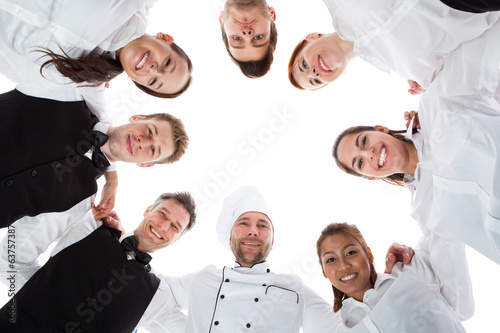 Photo: Waiters and waitresses standing in circle Waiters and waitresses standing in circle