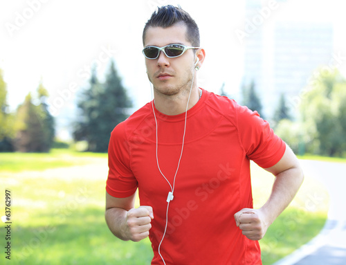 Photo: Sport - Runner. Man running with concentration Sport - Runner. Man running with concentration