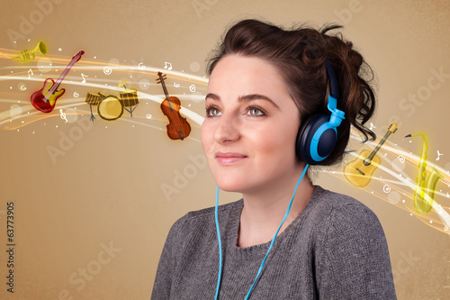 Photo: Young woman with headphones listening to music Young woman with headphones listening to music