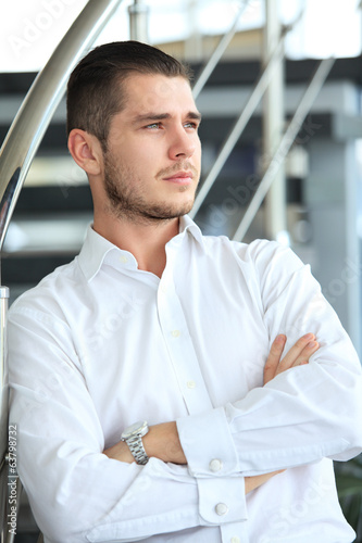 Photo: happy young business man in modern office happy young business man in modern office