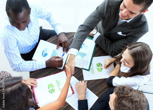 Photo: Business people shaking hands, finishing up a meeting Business people shaking hands, finishing up a meeting