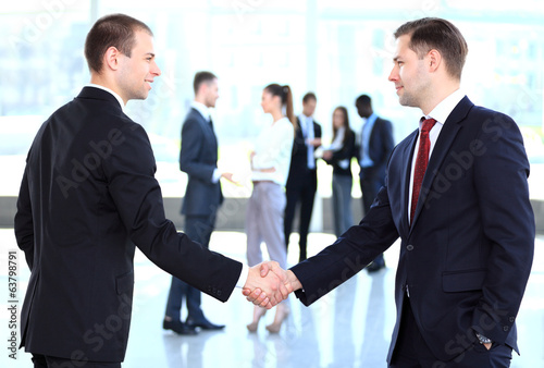 Photo: Business people shaking hands, finishing up a meeting Business people shaking hands, finishing up a meeting