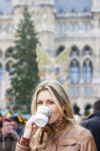 Photo: woman drinking hot wine at Christmas market, Vienna, Austria woman drinking hot wine at Christmas market, Vienna, Austria