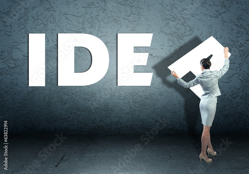 Photo: young businesswoman adds idea word young businesswoman adds idea word