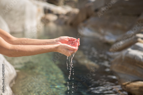 Photo: Human hands taking fresh water from river Human hands taking fresh water from river