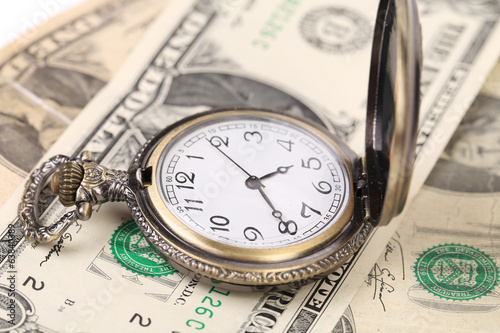 Photo: Pocket watch on money. Pocket watch on money.