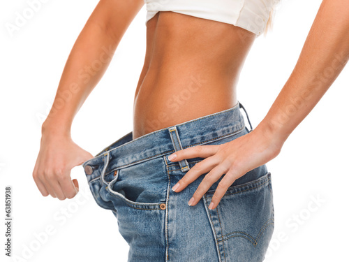Photo: close up of female showing big jeans close up of female showing big jeans