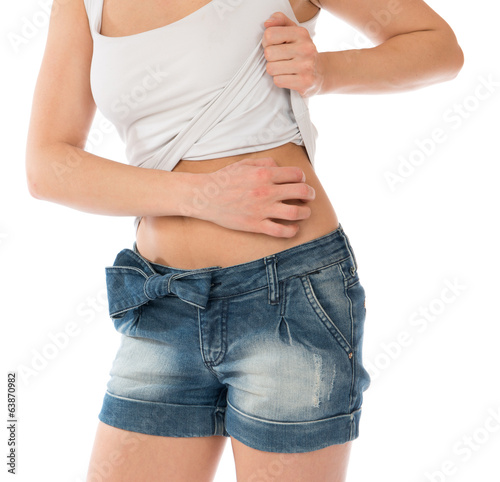 Photo: Young woman allergy scratching her abdomen stomach Young woman allergy scratching her abdomen stomach