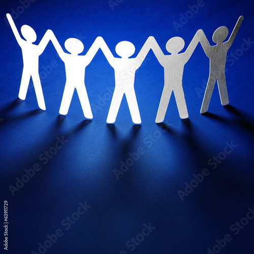 Photo: Group of paper people holding hands. Group of paper people holding hands.