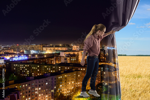 Photo: young woman pushes the curtain young woman pushes the curtain