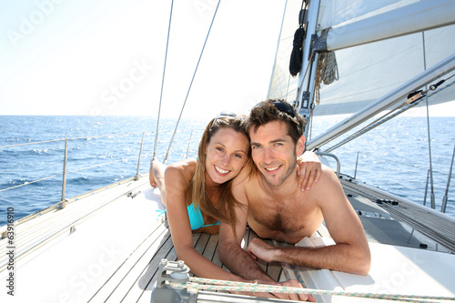 Photo: Lucky couple relaxing on sailboat deck Lucky couple relaxing on sailboat deck