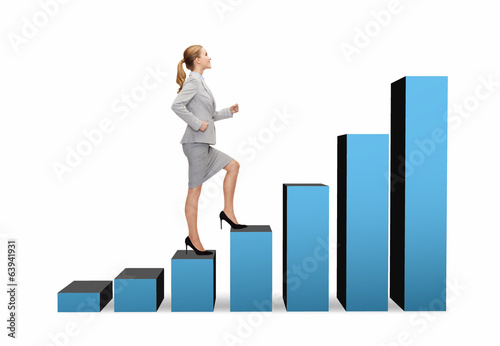 Photo: smiling businesswoman stepping on chart bar smiling businesswoman stepping on chart bar