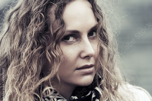 Photo: Sad beautiful woman with long curly hairs Sad beautiful woman with long curly hairs