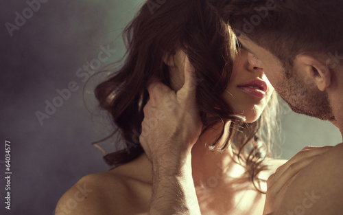 Sensual woman kissing her husband
