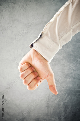 Photo: Businessman showing thumb down Businessman showing thumb down