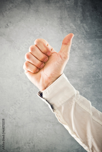 Photo: Businessman showing OK sign with his thumb up Businessman showing OK sign with his thumb up