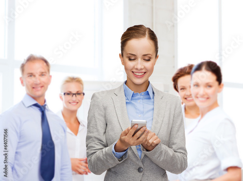Photo: young smiling businesswoman with smartphone young smiling businesswoman with smartphone