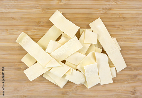 Photo: Wide egg noodles on cutting board Wide egg noodles on cutting board