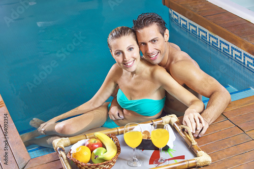 Photo: Couple eating breakfast in swimming pool Couple eating breakfast in swimming pool