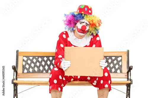 Photo: Sad clown holding a blank carton sign Sad clown holding a blank carton sign