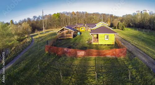 Photo: Several wooden houses with arbor on the territory Several wooden houses with arbor on the territory