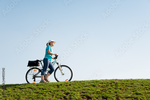 Photo: woman cycling outdoors woman cycling outdoors