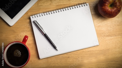 Photo: Overhead of notepad and pen Overhead of notepad and pen