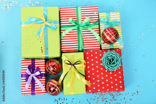 Photo: Many colorful presents with luxury ribbons on color Many colorful presents with luxury ribbons on color