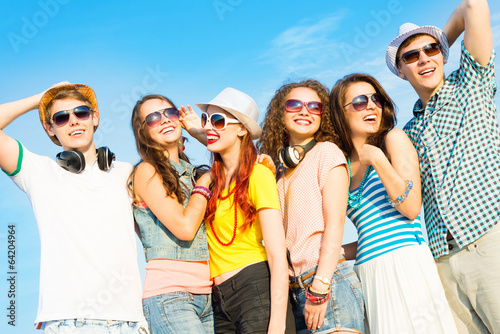 Photo: group of young people wearing sunglasses and hat group of young people wearing sunglasses and hat