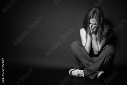 Photo: woman in depression and despair crying on black dark woman in depression and despair crying on black dark